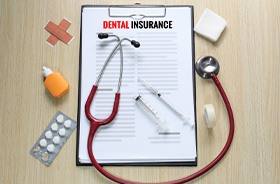 Dental insurance document on clipboard