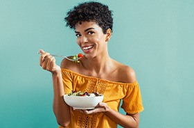 Smiling woman holding a bowl of food