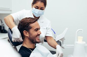 Smiling dental patient in treatment chair