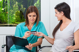 patient handing card to dental team member