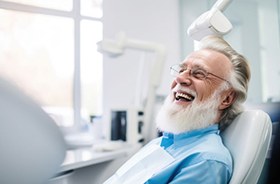 Happy older man in dental treatment chair