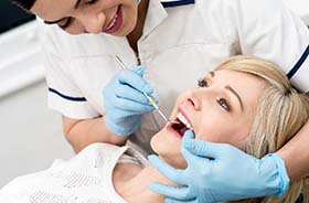 Woman visiting her dentist for dental checkup in Branford