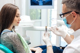 Dentist and patient discussing the cost of dental implants in Branford