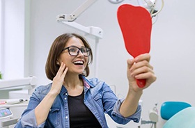 Young woman admiring her new dental implants in Branford