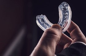 Athlete’s hand holding a mouthguard