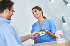 Patient paying for services at dental office front desk