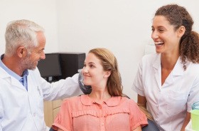 Young female patient speaking with dental team