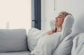 Content woman relaxing on her sofa at home